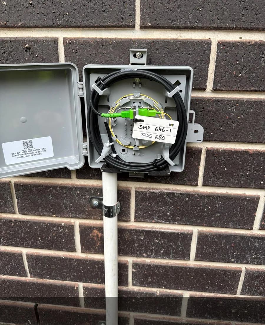 Fibre cable routed inside an outdoor connection enclosure